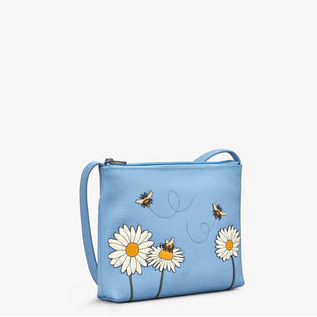 Blue handbag with floral and bee designs on a light blue background