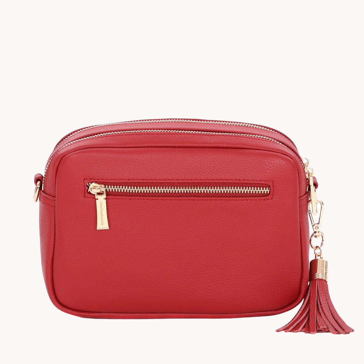 Red handbag with a gold zipper and tassel on a white background