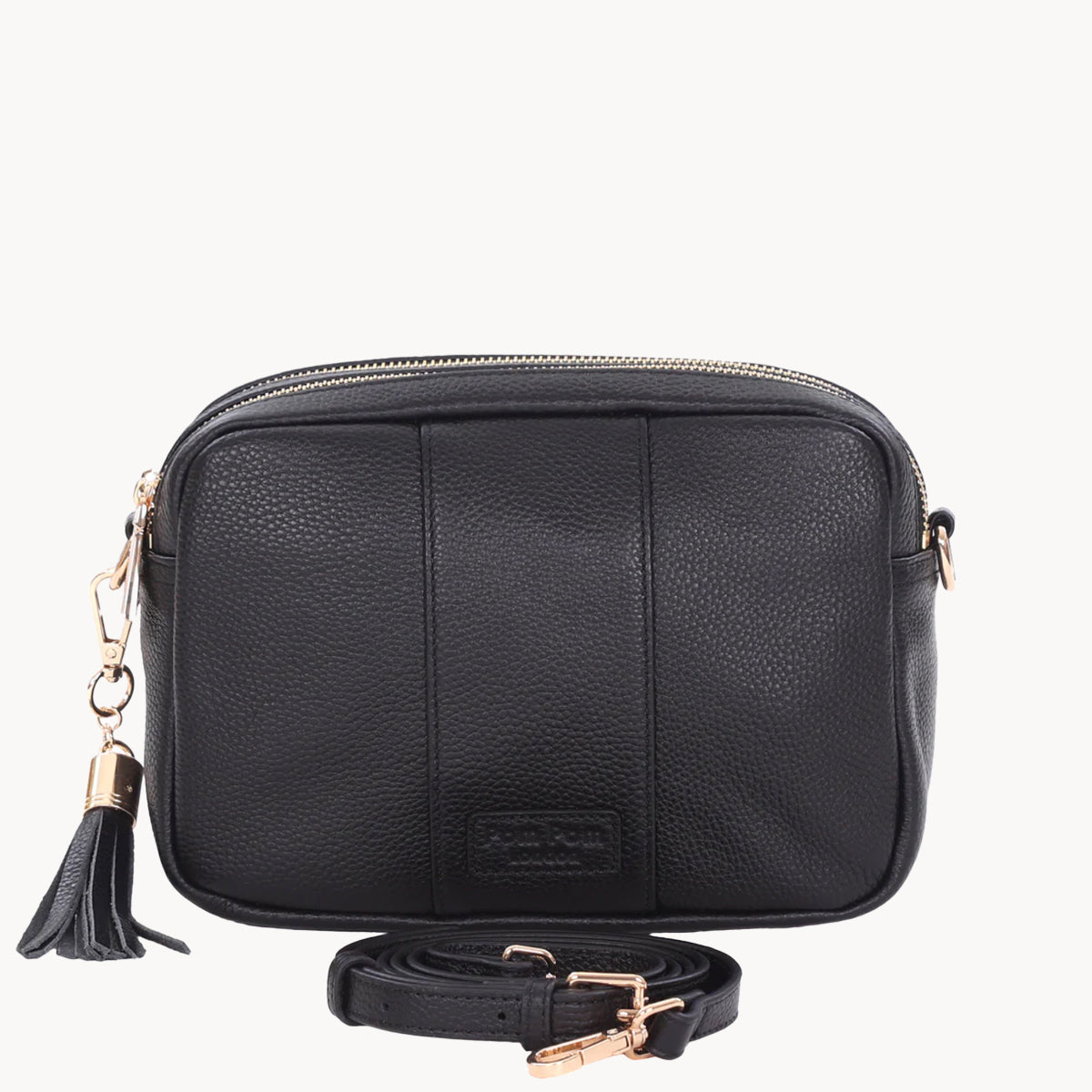 Black leather crossbody bag with a tassel on a white background