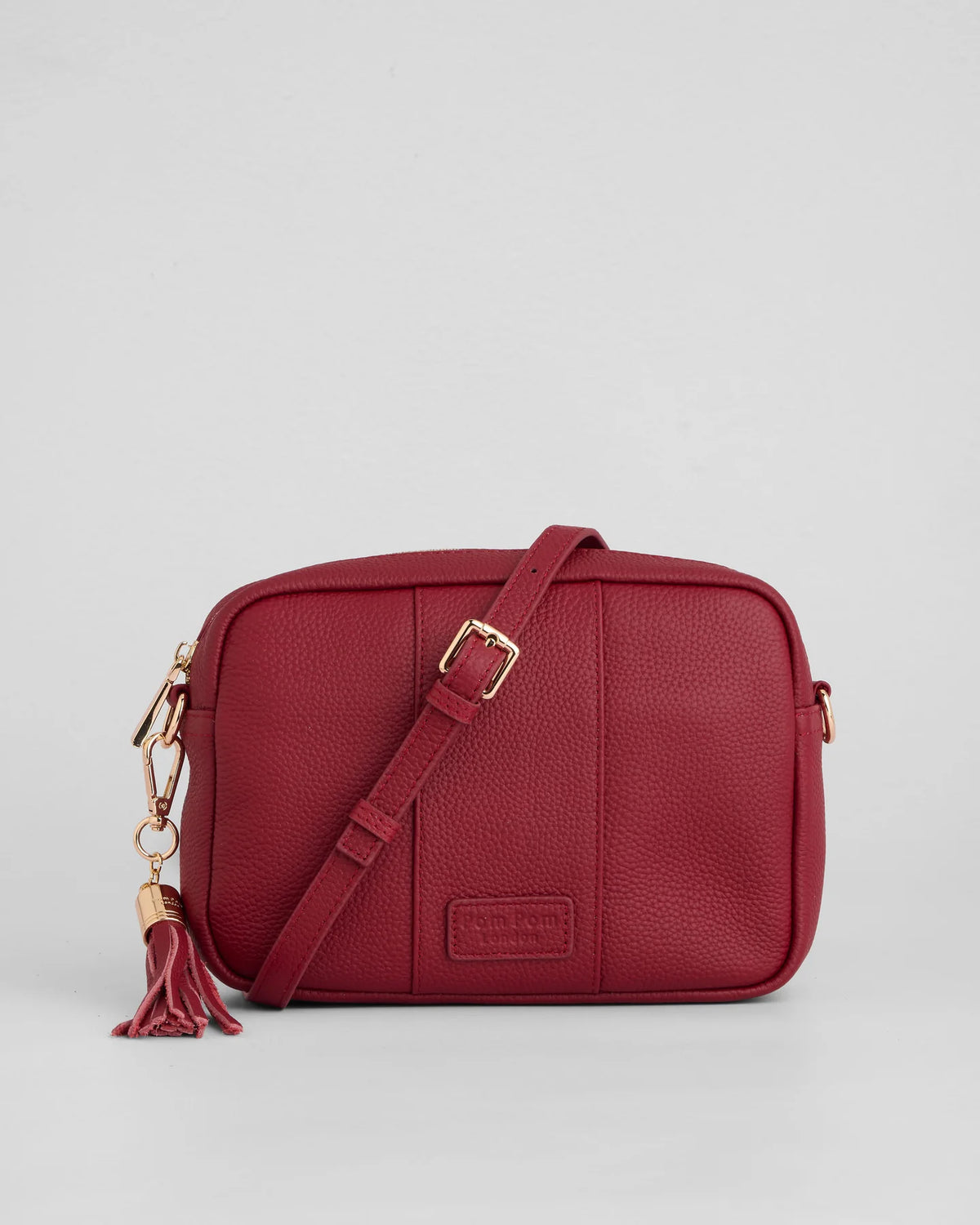Burnt Rhubard red pebble leather crossbody bag with tassle and gold hardward