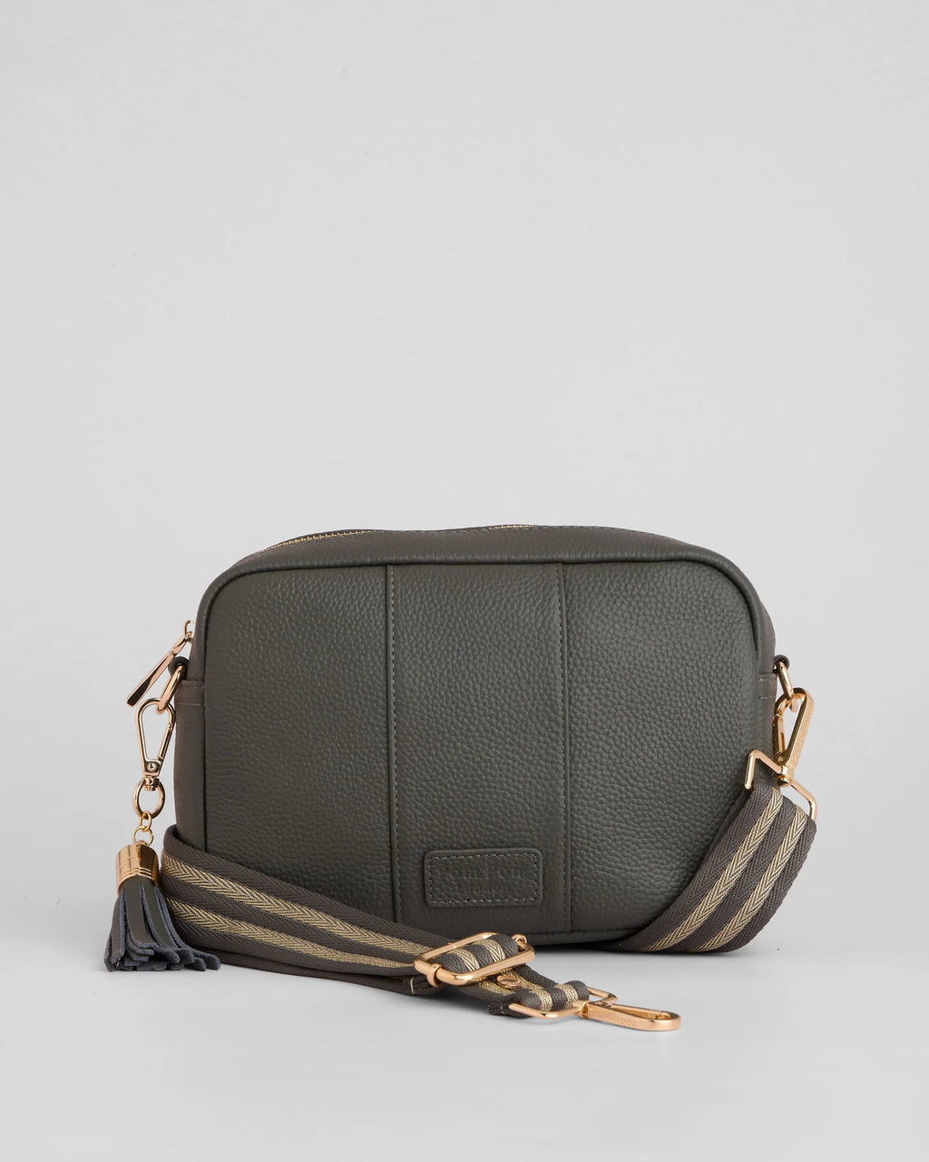 Volcano Grey pebble leather crossbody bag with tassle and gold hardward with interchangable fabric strap