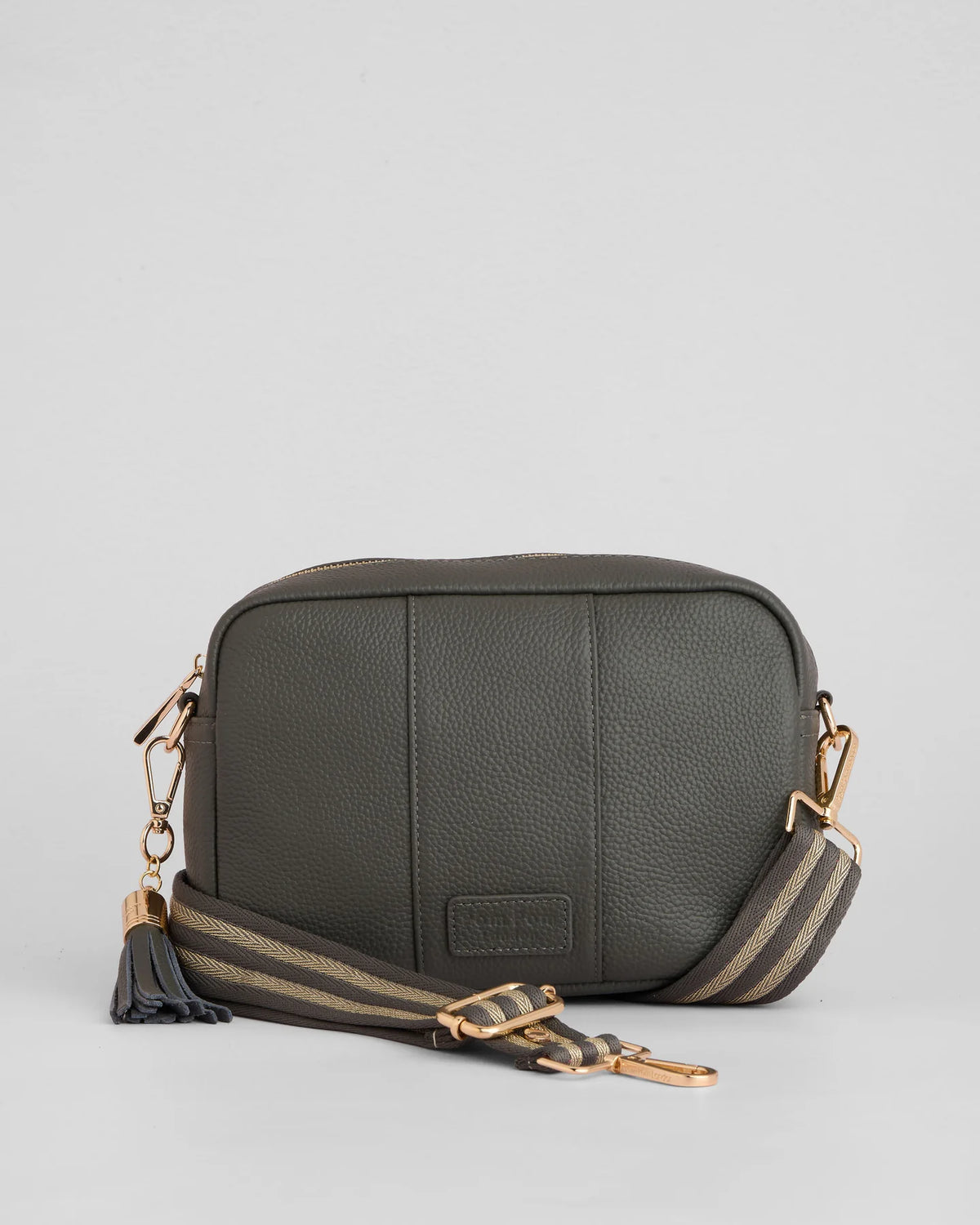 Volcano Grey pebble leather crossbody bag with tassle and gold hardward with interchangable fabric strap