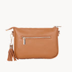Tan leather handbag with a tassel on a white background