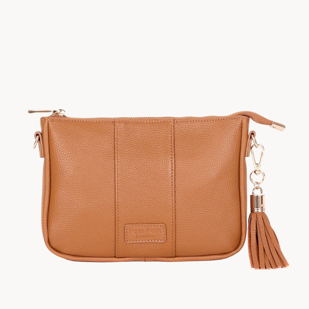 Tan leather clutch bag with a tassel on a white background