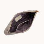 Open stone clutch bag with gold zipper on a light gray background