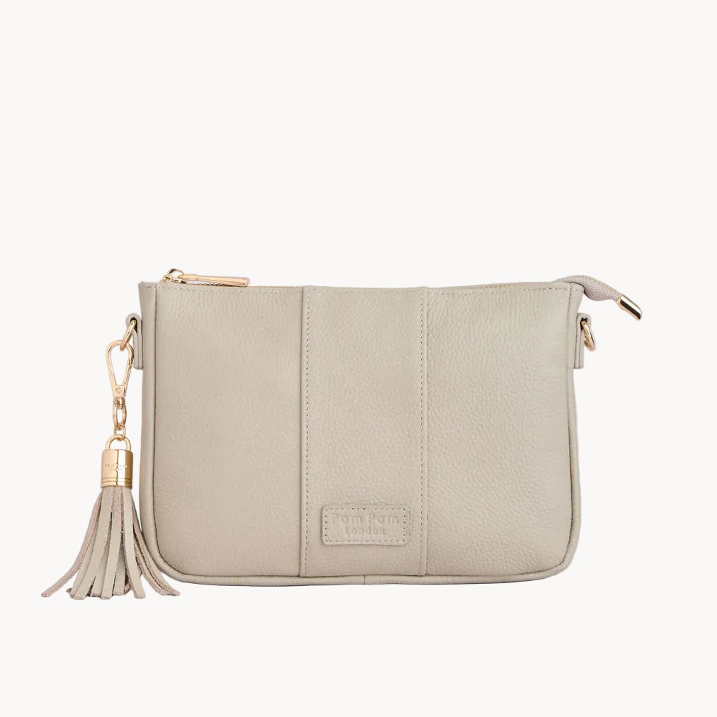 Stone handbag with a tassel on a light gray background