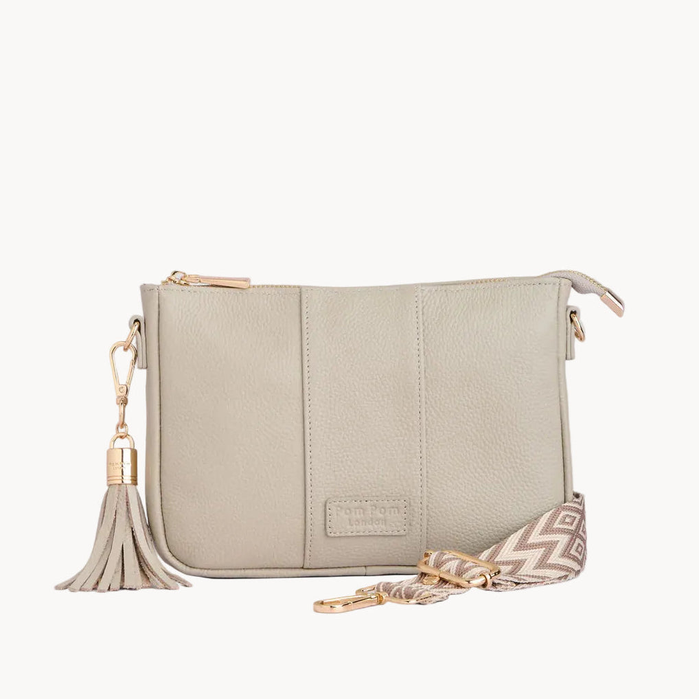 Stone handbag with a tassel on a light gray background