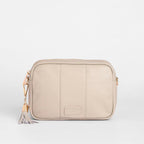 Beige crossbody bag with a tassel on a white background