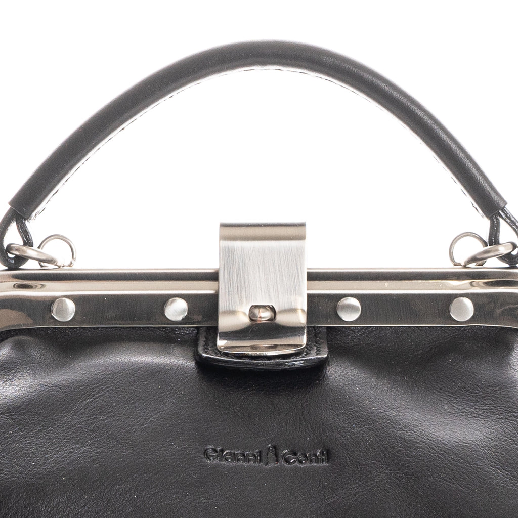Close-up of black Italian leather handbag clasp detail