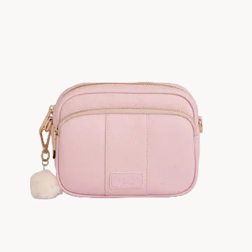 Pink crossbody bag with a pom-pom on a gray background