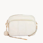 White leather handbag with gold chain strap on a light gray background