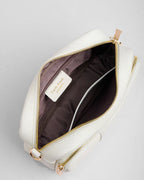 White leather bag with gold zipper on a light gray background