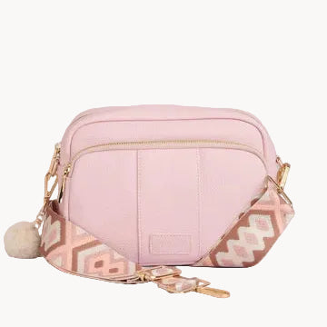 Pink crossbody bag with geometric pattern on a light gray background