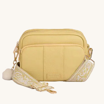 Yellow crossbody bag with a decorative band on a gray background