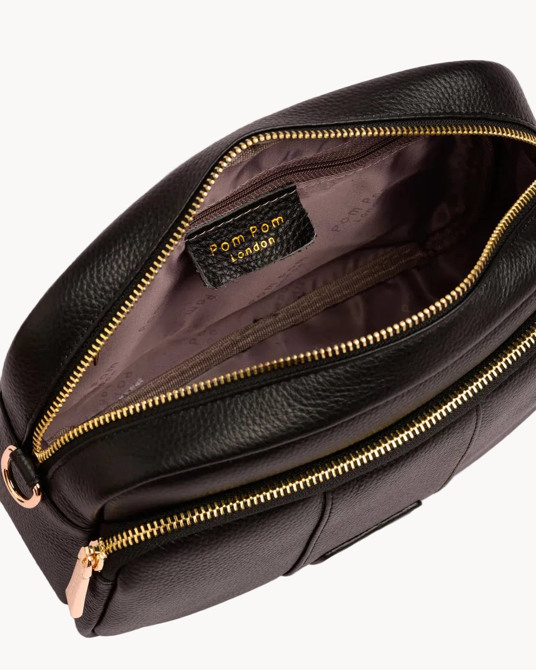 Black leather bag with gold zipper on a white background