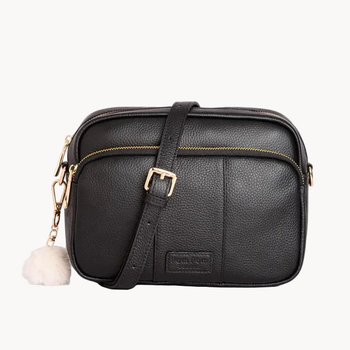 Black leather crossbody bag with gold accents on a light gray background