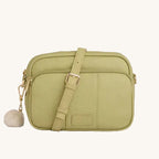 Green crossbody bag with a strap on a light gray background