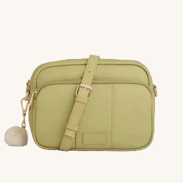 Green crossbody bag with a strap on a light gray background