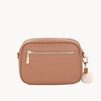 Brown crossbody bag with a white pom-pom on a white background