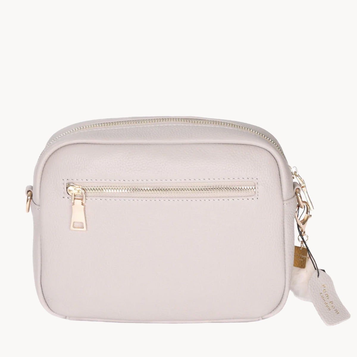 Stone crossbody bag with gold zipper and tag on a white background
