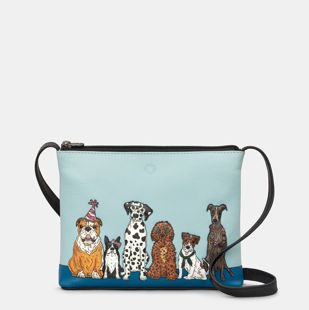 Crossbody bag with illustrations of dogs on a light blue background