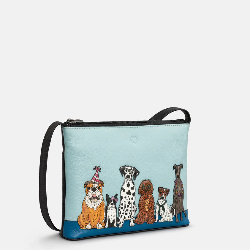 Crossbody bag with illustrations of dogs on a light blue background