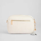 White handbag with gold accents on a light gray background