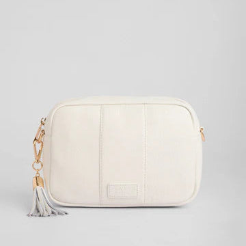 White leather bag with a tassel on a light gray background