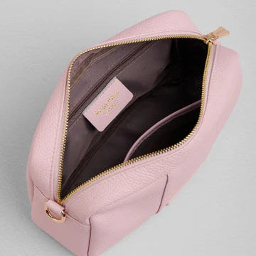 Pink bag bag with gold zipper on a light gray background