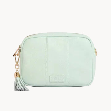 Mint green bag with a tassel on a light gray background