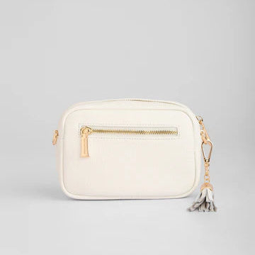 White handbag with gold accents on a light gray background