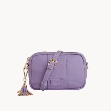 Purple crossbody bag with a tassel on a light gray background