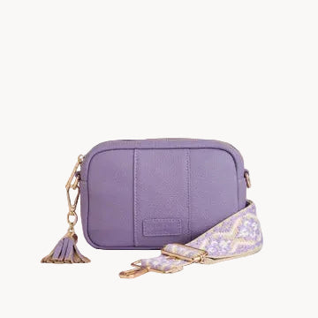 Purple crossbody bag with a matching strap on a light gray background