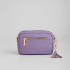 Purple handbag with gold accents on a light gray background