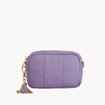 Purple crossbody bag with a tassel on a light gray background