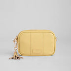 Yellow bag with a keychain on a light gray background