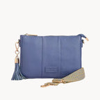Blue handbag with a tassel on a light gray background