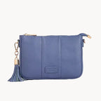 Blue clutch bag with a tassel on a gray background