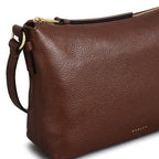 Brown leather handbag with a visible brand logo on a white background