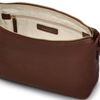 Brown leather bag with a visible brand label on a white background