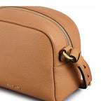 Tan leather handbag with a gold zipper and strap on a white background