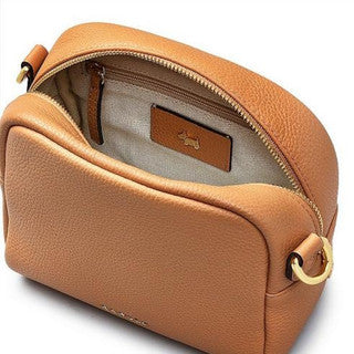 Tan leather handbag with gold zipper on a white background