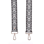 Two strap ends with black and white geometric pattern on a white background
