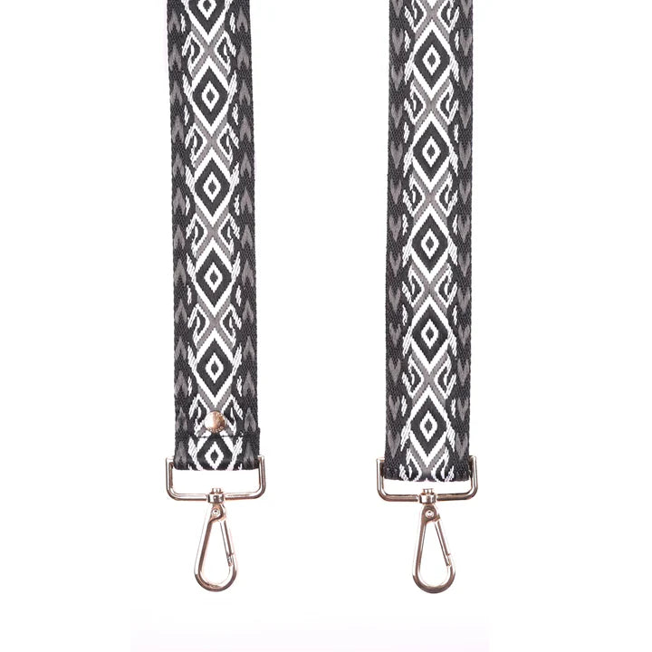 Two strap ends with black and white geometric pattern on a white background