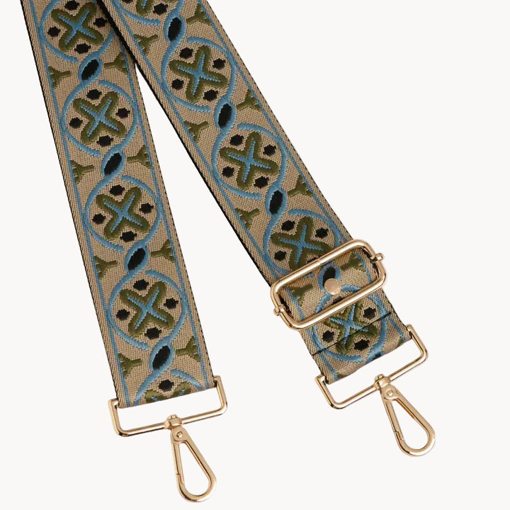Patterned strap with gold hardware on a white background
