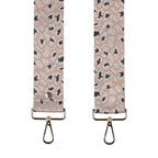 Patterned strap with metal hooks on a white background