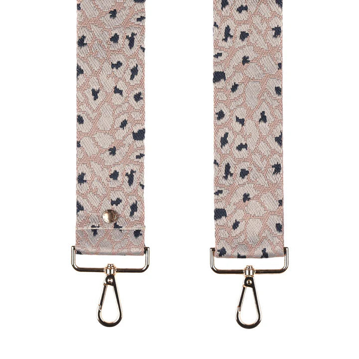 Patterned strap with metal hooks on a white background