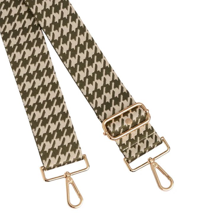 Houndstooth patterned strap with gold hardware on a white background