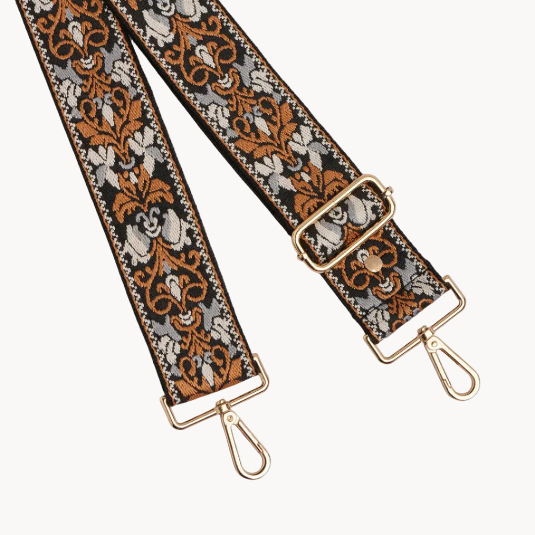Decorative bag strap with floral pattern on a gray background