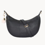 Black leather handbag with gold accents on a white background
